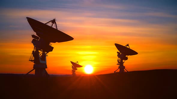 Three Radio Telescopes Against Scenic Sunset Exploring Evening Sky