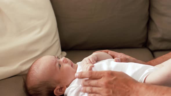 Middle Aged Father with Baby Daughter at Home