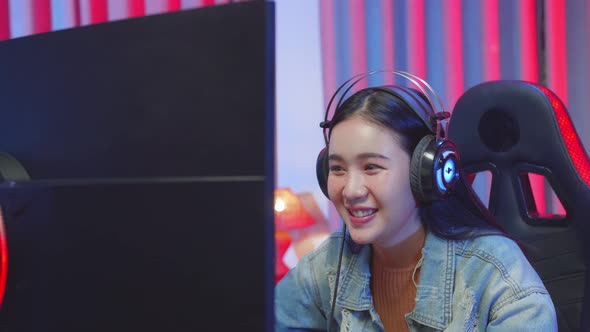 Excited Asian Girl Playing Video Game 