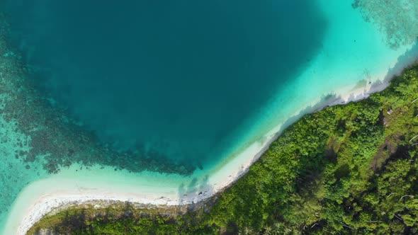 Aerial: flying over exotic white sand beach tropical island secluded destination away from it all