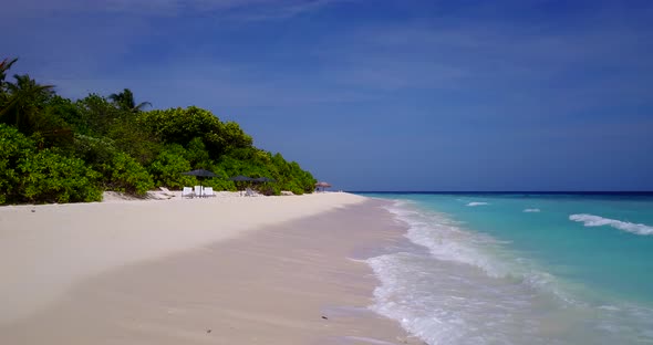 Tropical overhead tourism shot of a summer white paradise sand beach and aqua blue ocean background 