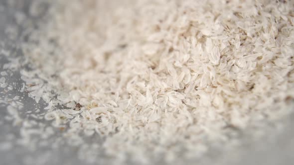 Psyllium husks are poured into a gray bowl