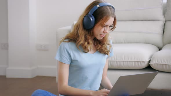 Girl Using Smartphone and Laptop with Headphones