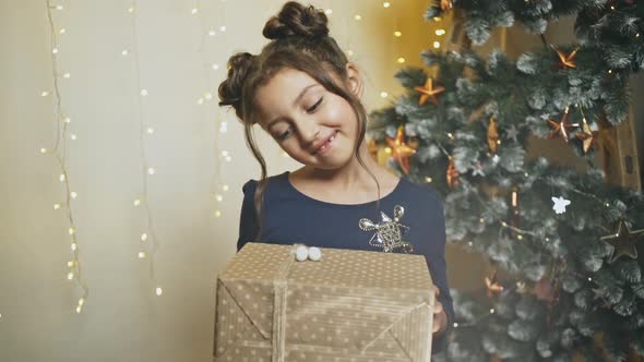 A Point of View Perspective of an Excited Young Girl Giving a Present While Standing Beside a