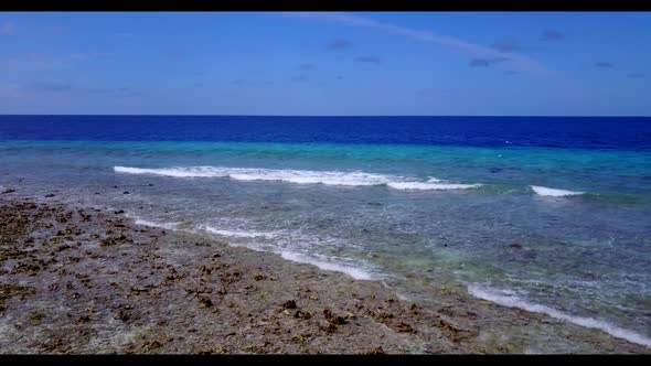 Aerial above texture of perfect coastline beach trip by blue green water with white sand background 