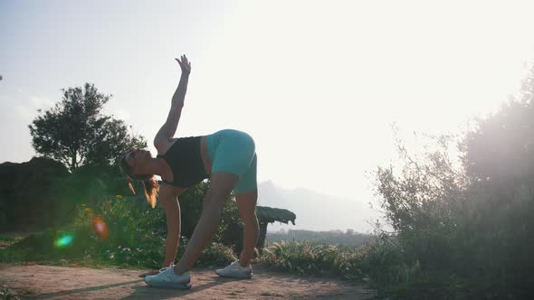 Sportive Woman Stretching to the Ground Outdoors