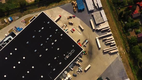 Aerial view of goods warehouse. Logistics delivery center in industrial city zone from above. Aerial