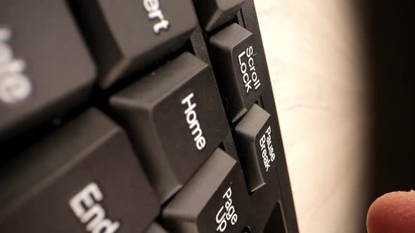 Person Finger Presses Black White Pause Break on Keypad