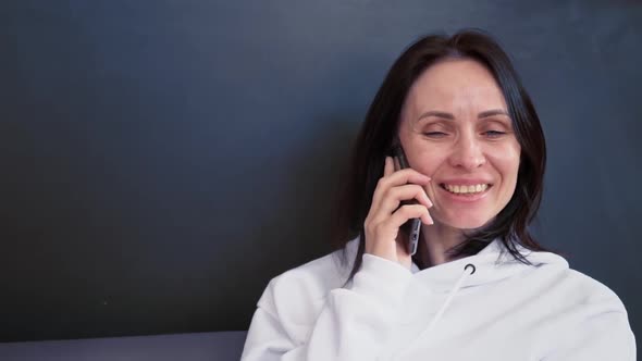 Focused Business Woman Talking on Mobile Phone at Home Office in Slow Motion