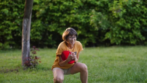 Mother and Son Play Frisbee on Grass Lawn