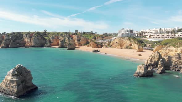 Praia de Dona Ana beach with emerald  sea water and cliffs, Algarve,  Portugal.