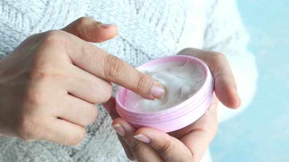 Woman Applying Beauty Cream Onto Skin at Home 