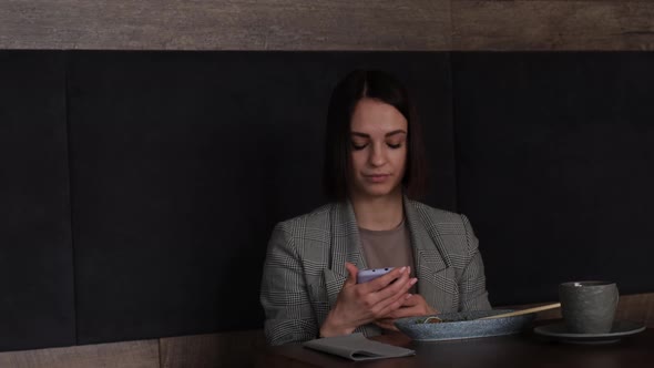 Brunette Woman Eating Sashimi in Japanese Restaurant