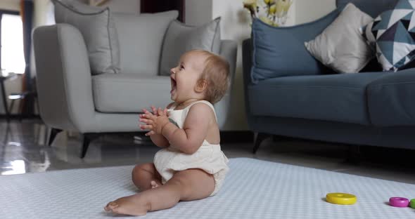 Authentic Close Up Cute Caucasian Baby Girl 1 Year Old Playing on Floor in Living Room at Home