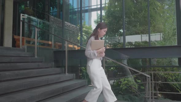 young Asian women walking for work at co-working space modern office