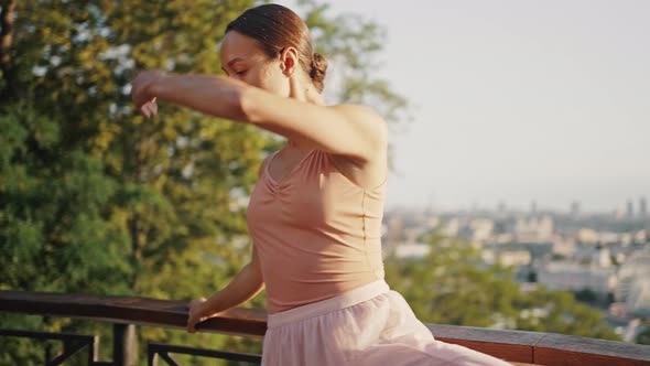 Flexible Ballerina Holds on to Fencing Making Ballet Moves