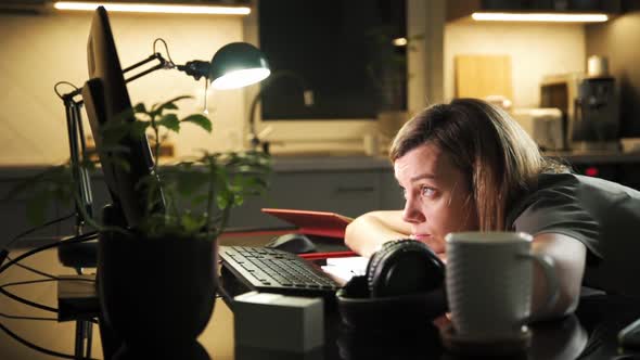 Tired Woman Works Remotely at Computer