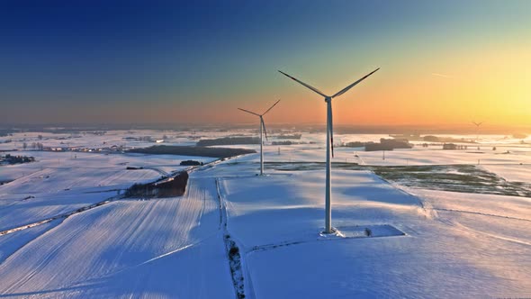 Wind turbine on snowy field in winter. Alternative energy, Poland