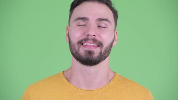 Face of Happy Young Handsome Bearded Man Relaxing with Eyes Closed