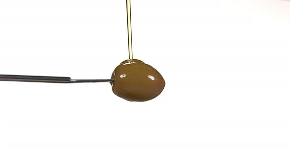 Olive and Olive Oil against White Background, Slow Motion 4K