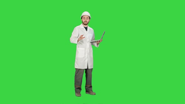 Technical Working in Helmet Talking on Camera Hand Gestures  on a Green Screen, Chroma Key