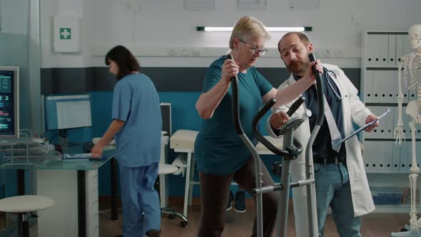 Senior Patient Doing Muscle Exercise on Stationary Bicycle