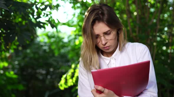 Young Female Agricultural Engineer Working in Greenhouse