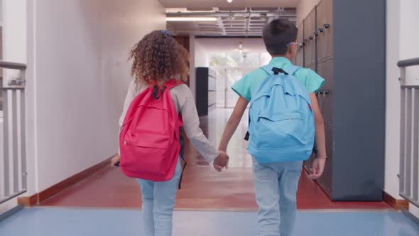 Diverse Couple of Schoolkids Leaving School