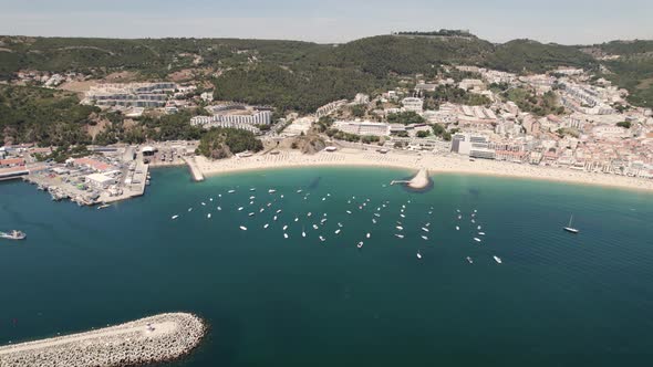 Motorboats and yachts anchored on calm Atlantic Ocean off Ouro Beach, Sesimbra