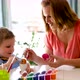 Young Mother and Her Son Having Fun While Painting Eggs for Easter - VideoHive Item for Sale