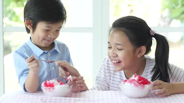 Happy Little Asian Children  Eating Shaved Ice At Home