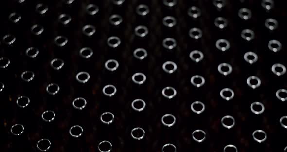 Close-up of brown bottles in a factory. A long row of glass bottles. Top view of a production line.