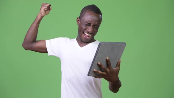 Young Happy African Man Using Digital Tablet