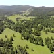 Green Meadows in The Sparsely Wooded Between Forest Covered Hills with Aerial View - VideoHive Item for Sale