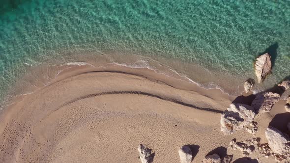 Aerial Drone View of Tropical Sandy Beach with Clear Ocean Waves