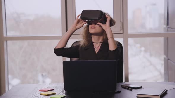 Female Sitting Front of Laptop Screen in Office Room.