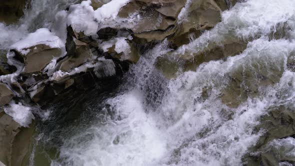 Waterfall Prut in the Winter. Rapid Flow of Water From a Mountain Creek and Stone Rapids with Snow