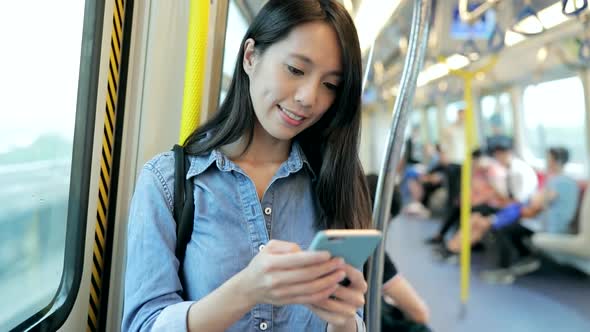 Woman use of mobile phone on train 