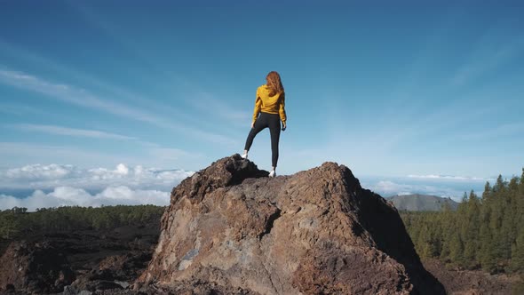 Young Woman Tourist Climbed to the Top of a Volcanic Stone