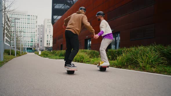 Men Riding Electric Skateboards