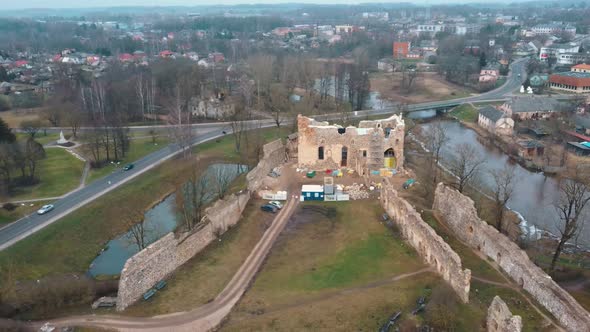 Medieval Castle the Town of Dobele on the West Bank of the River Berze in Winter. Aerial 4K Video