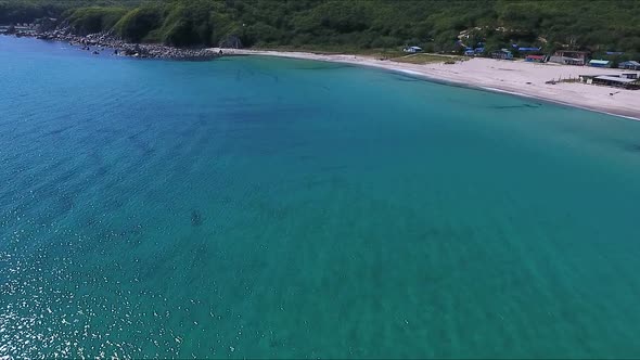 Flying Over the Blue Sea Surface in the Azure Lagoon