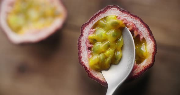 Table Top Video of Taking Out the Ripe Passion Fruit with Spoon in Slow Motion Exotic Tropical