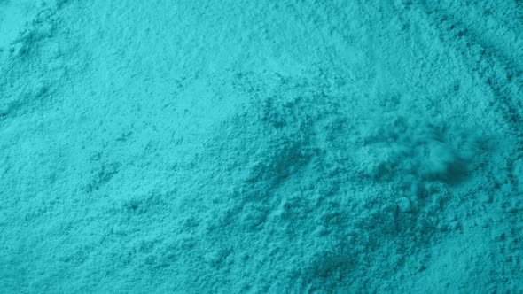 Light Blue Powder Pouring Into Pile