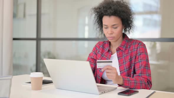 African Woman Making Online Payment Failure on Laptop