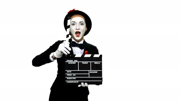 Woman Mime Uses the Movie Clapper on White Background