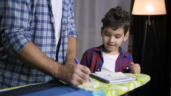 Positive Son and Dad Learning Together at Home