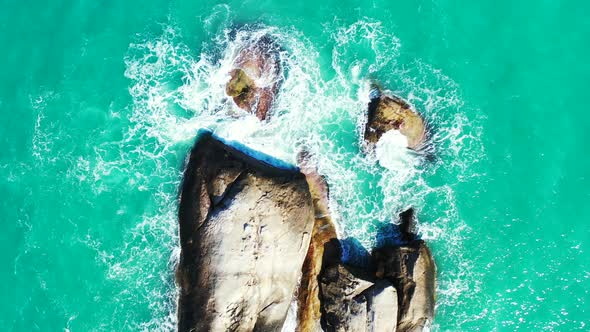 Wide overhead travel shot of a summer white paradise sand beach and aqua turquoise water background 