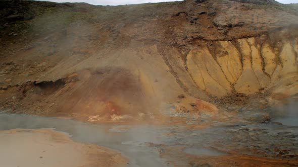 dramatic iceland landscape, geothermal hot spring steam smoke rising from the pools of hot water, kr