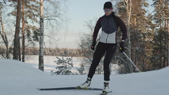 Woman Skiing in Forest